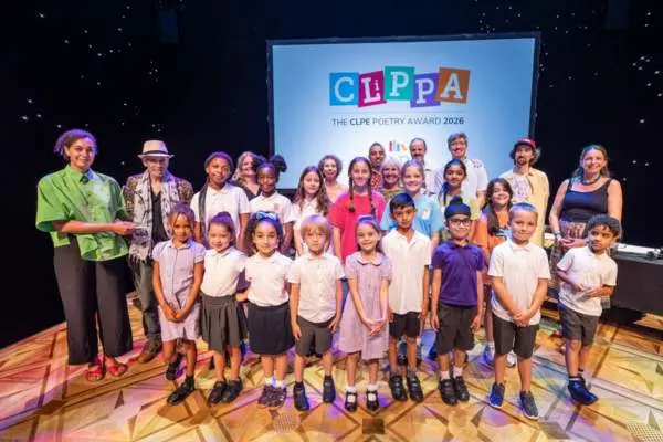 Photo of all the winners of the CLiPPA Shadowing Scheme 2026 on stage at the Lyttleton Theatre, London with winner John Agard.